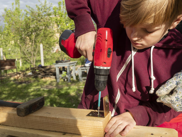 Close-up of boy working outdoors