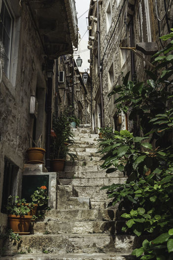 Narrow alley amidst old buildings in city