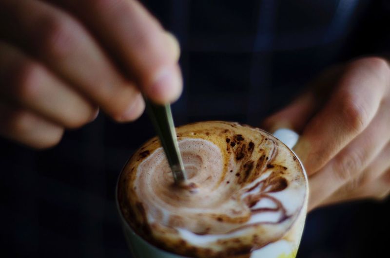 Close-up of hand holding coffee cup