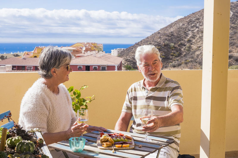 Senior couple having food at outdoors restaurant