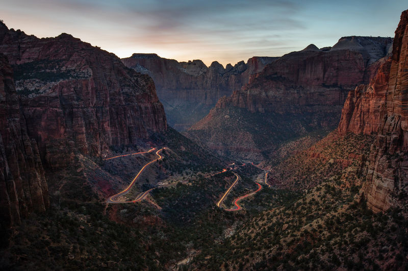 Aerial view of light trails on road amidst canyons