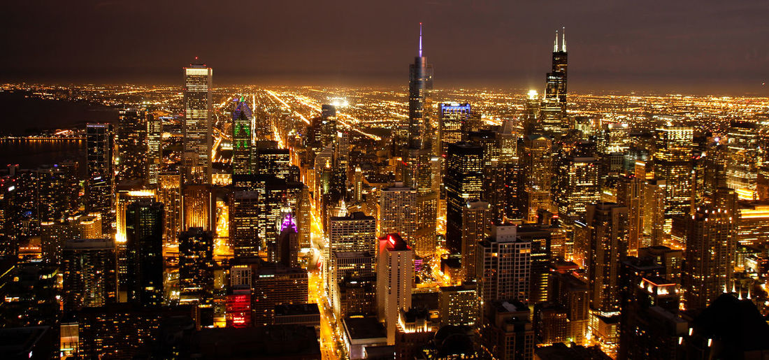 Illuminated cityscape of chicago against sky at night