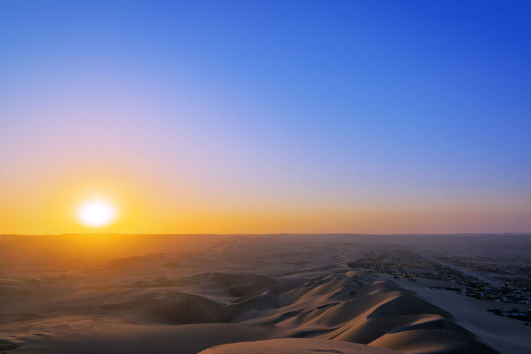 Scenic view of desert against sky during sunset at huacachina