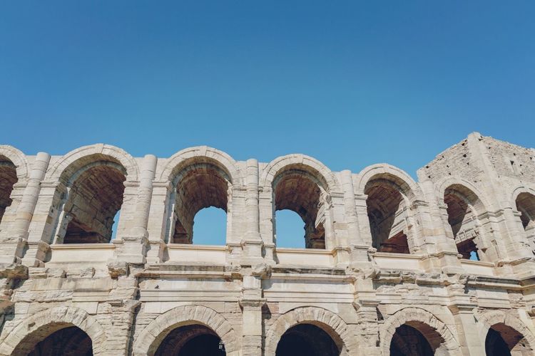 Low angle view of arles amphitheatre against clear sky