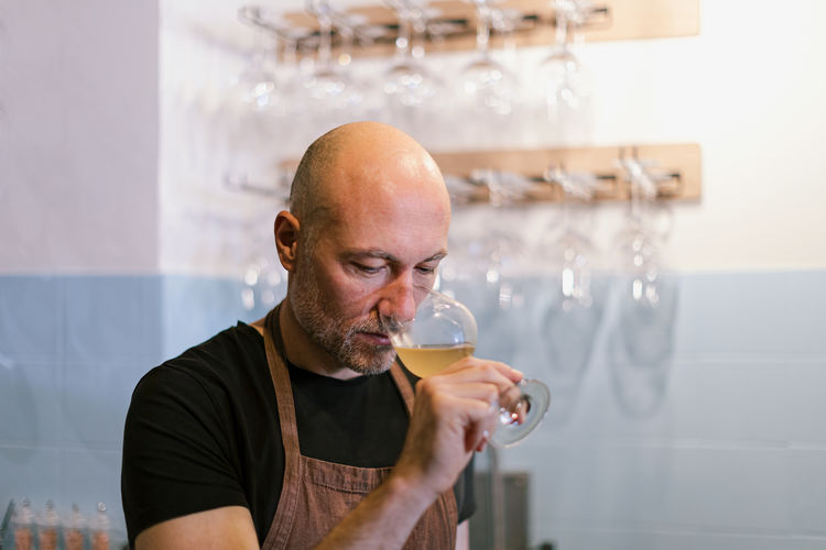 Sommelier smelling white wine in a glass