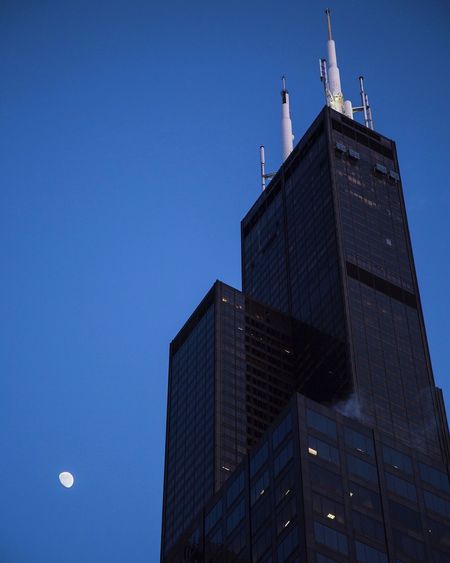 Low angle view of willis tower against blue sky at dusk