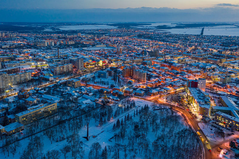 Beautiful evening top view of the city. winter city in the snow.