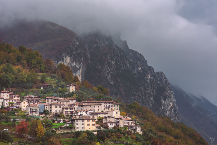 Buildings in mountains against sky