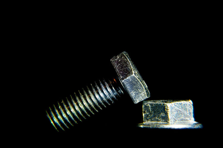 Close-up of metallic structure against black background