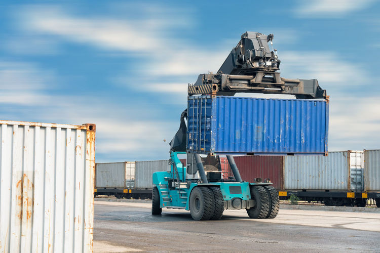 Vehicle lifting containers at commercial dock