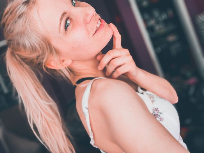 Portrait of young woman touching chin