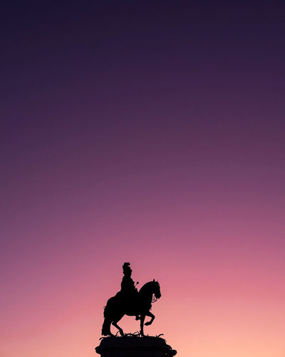 Silhouette statue against clear sky during sunset