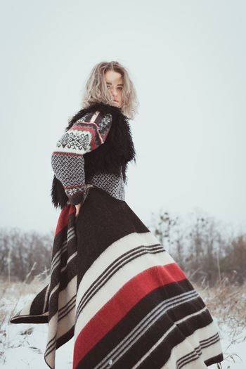 Pretty lady with woolen plaid in winter scenic photography
