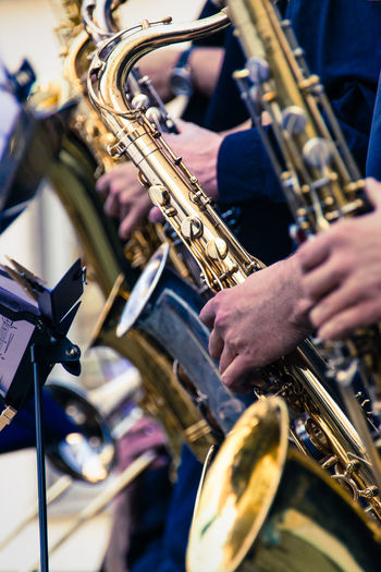 Cropped image of musician playing saxophone during music concert
