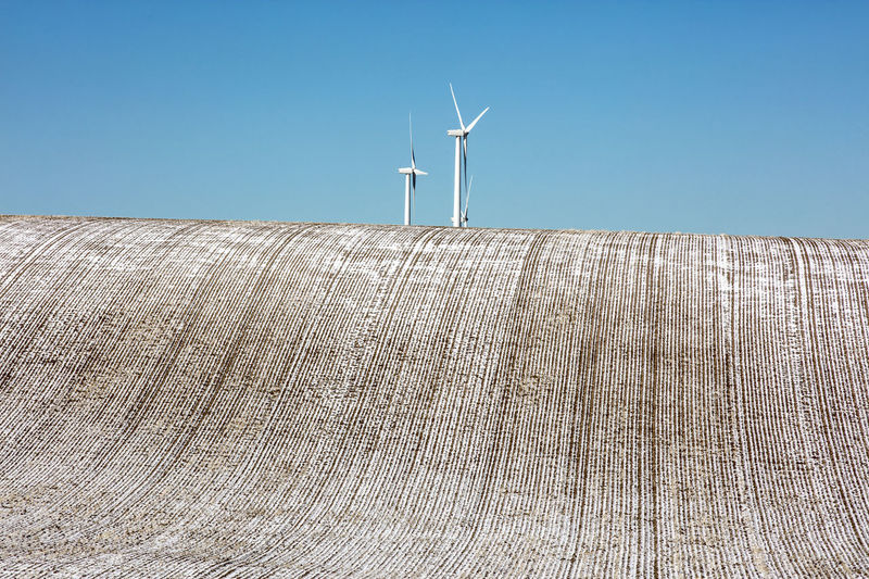 LOW ANGLE VIEW OF WIND TURBINES AGAINST SKY