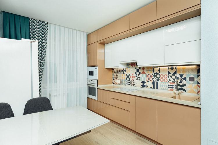 Beautiful beige modern kitchen with appliances