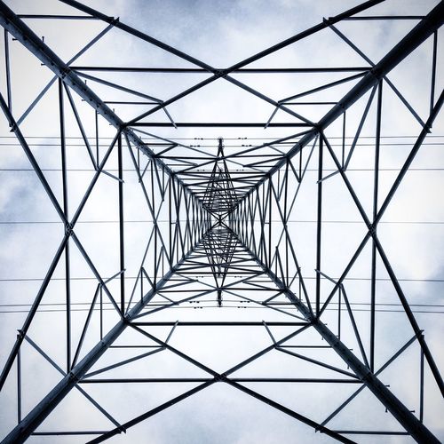 Low angle view of electricity pylon against sky