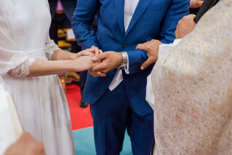 Close-up of wedding couple holding hands