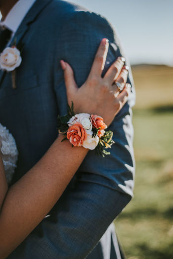 Close-up of woman hand holding red flower