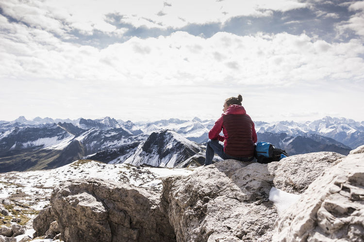 Germany, bavaria, oberstdorf, hiker sitting in alpine scenery