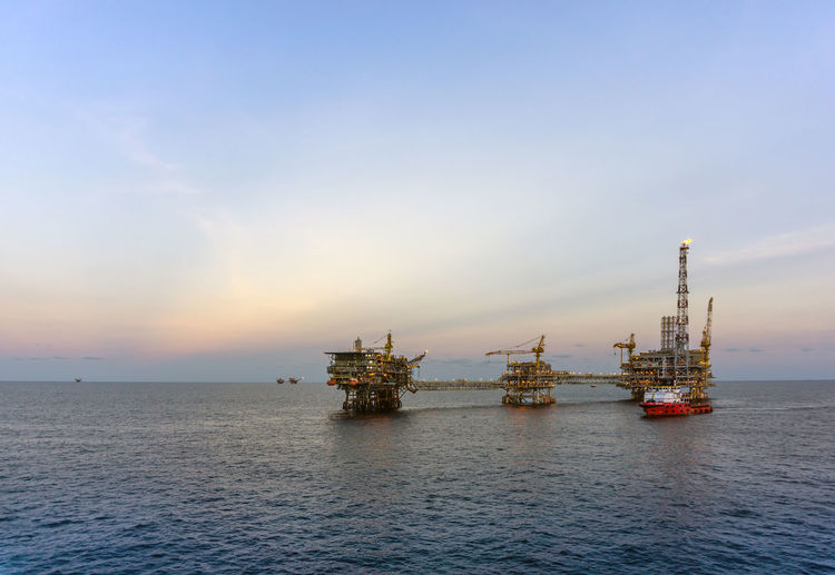 Scenery of an oil production platform during sunrise at offshore oil field