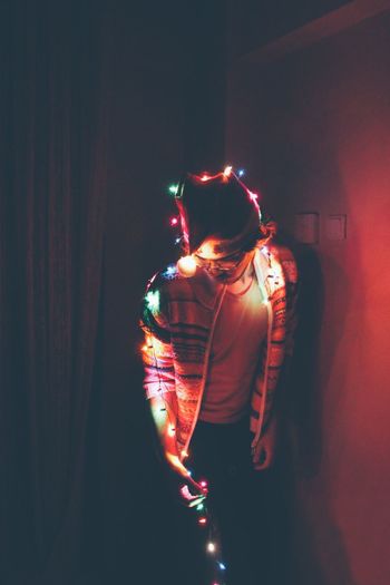 Man posing with christmas lights at home