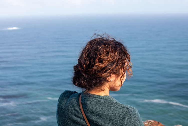 Rear view of woman looking at sea