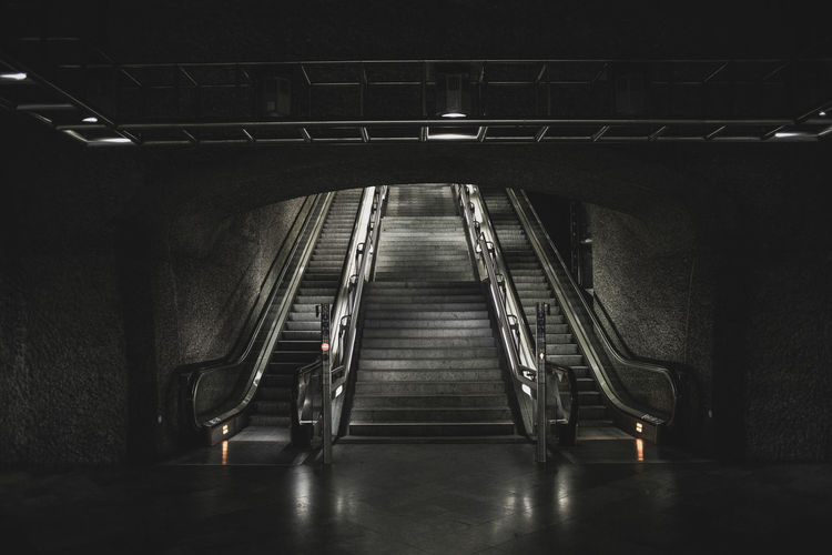 Staircase in illuminated tunnel