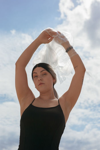 Portrait of woman standing against sky
