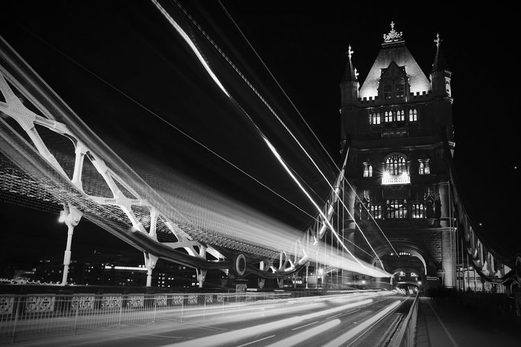 Illuminated tunnel at night