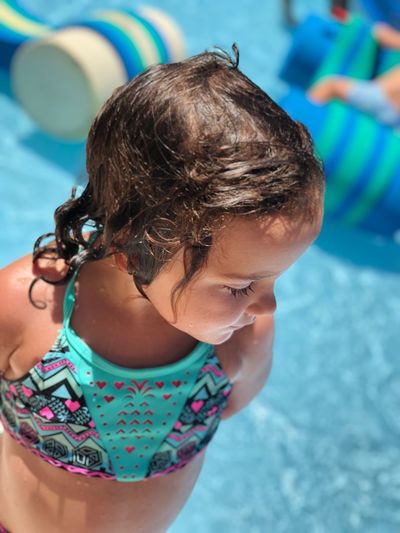 Close-up of girl by swimming pool