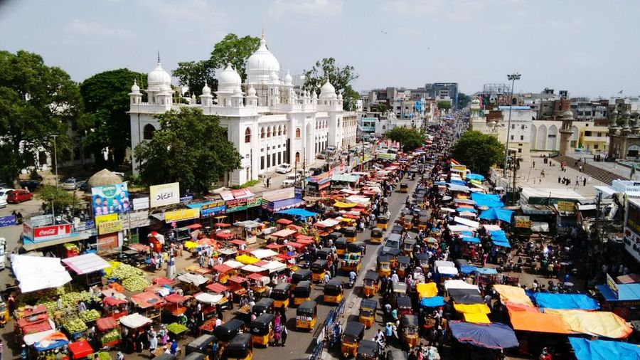 High angle view of vehicles amidst buildings on sunny day in city