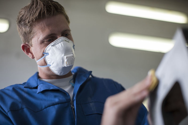 Midsection of man wearing surgical mask