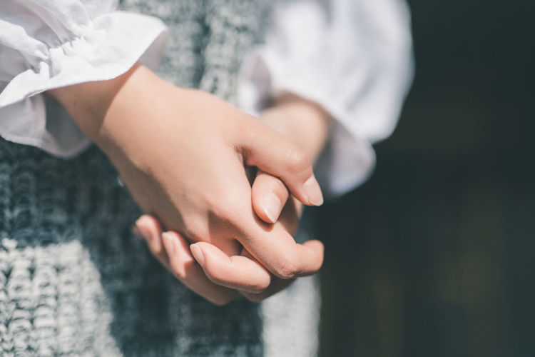 Close-up of woman with hand clasped