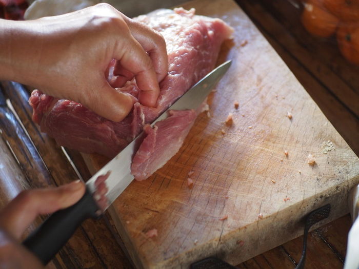Close-up of woman chopping meat