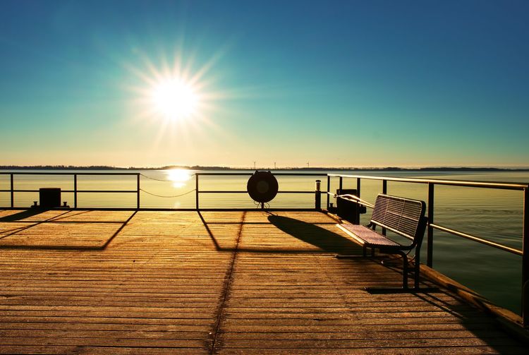 Empty wooden pier at beautiful colorful morning. tourist wharf in bay of sea.