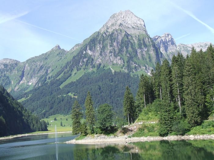 Panoramic shot of calm lake in front of mountains
