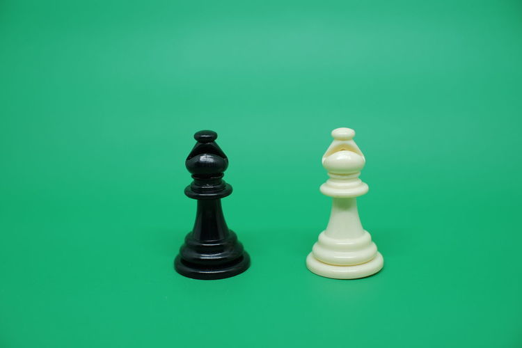 Close-up of chess pieces against green background