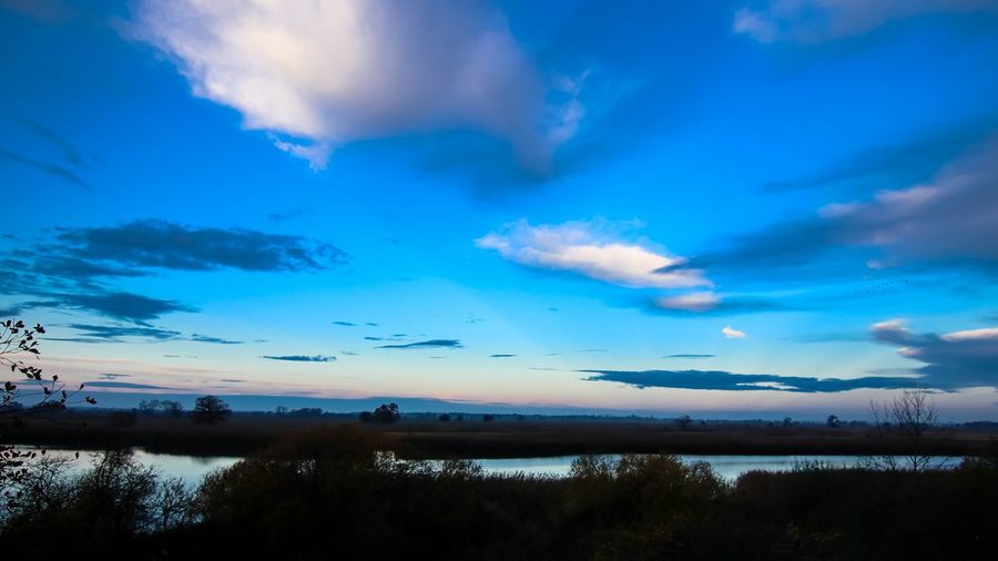 Scenic view of lake against blue sky