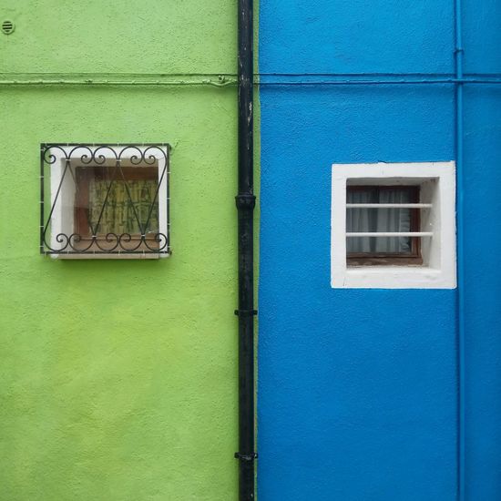 Close-up of window on green door
