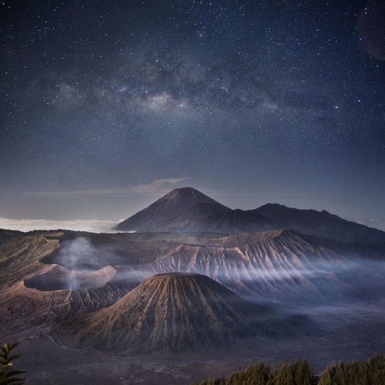 Scenic view of mountains against sky at night
