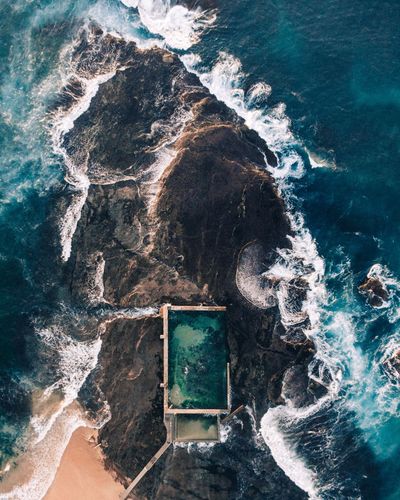 High angle view of waves splashing in sea