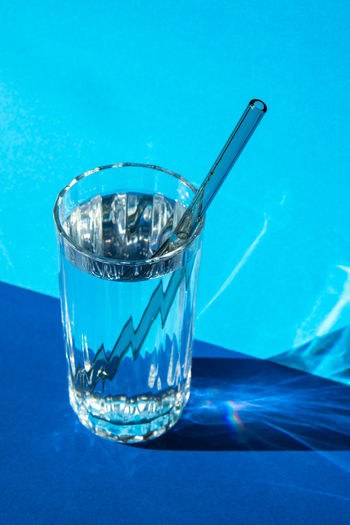 Close-up of glass against blue background