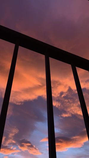 Low angle view of silhouette metal against sky during sunset
