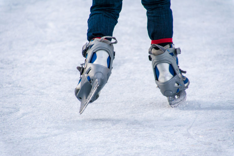 Low section of person skating on ice