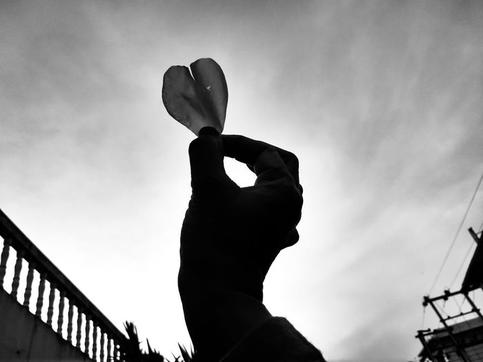 Low angle view of silhouette man against sky