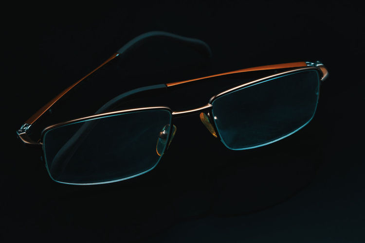 Close-up of sunglasses against black background