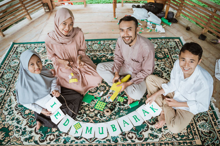 High angle view of family holding text at home
