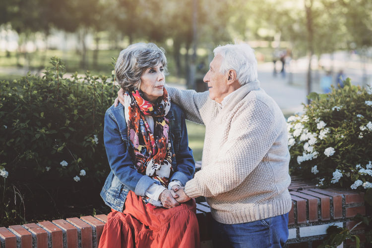 Senior adult embracing at park