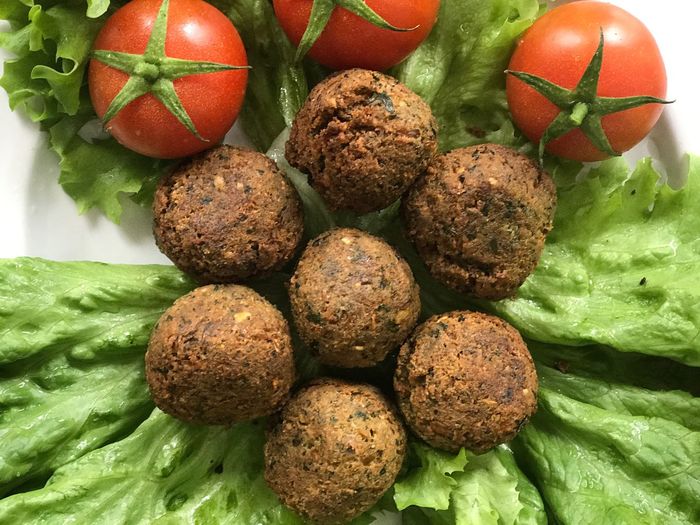 Close-up of falafels with cherry tomatoes and lettuce in plate